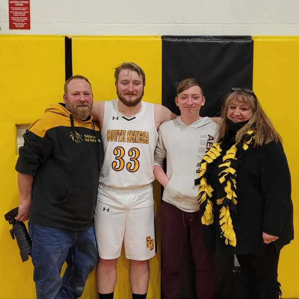 Photo of senior athlete with his parents