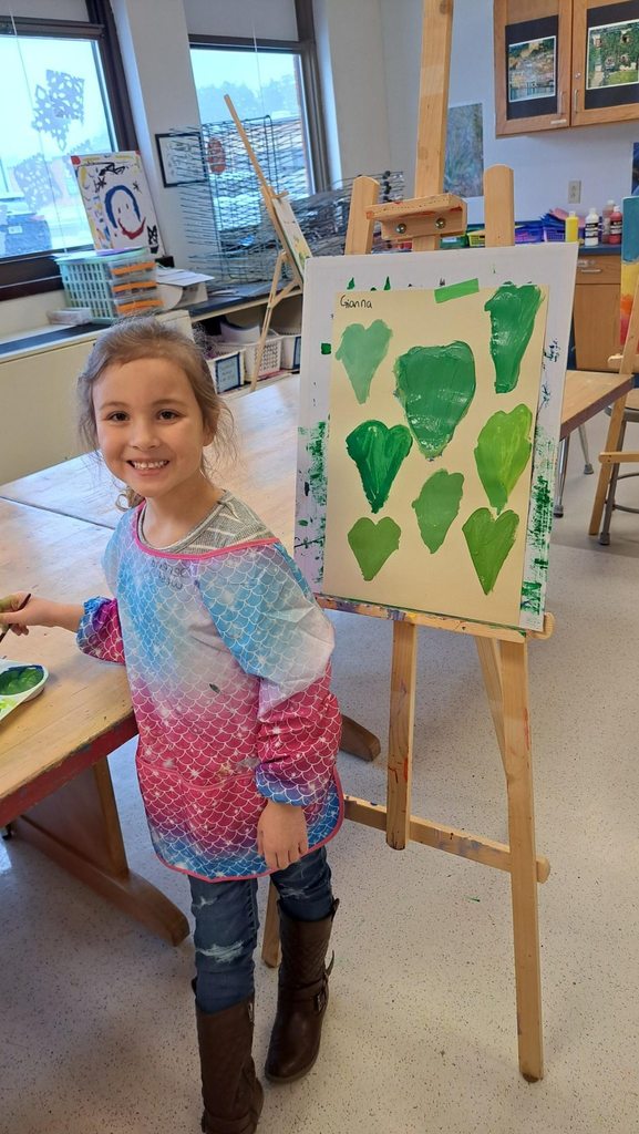 Kindergarteners focused on their paintings